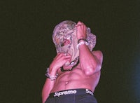 a man wearing a shirt with a mask on his face